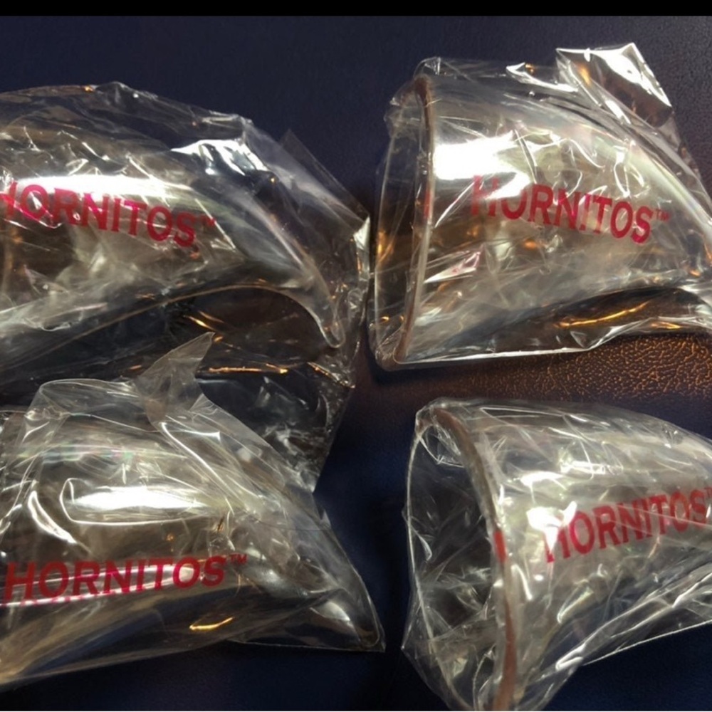 Four plastic hornitos horn shot glasses
